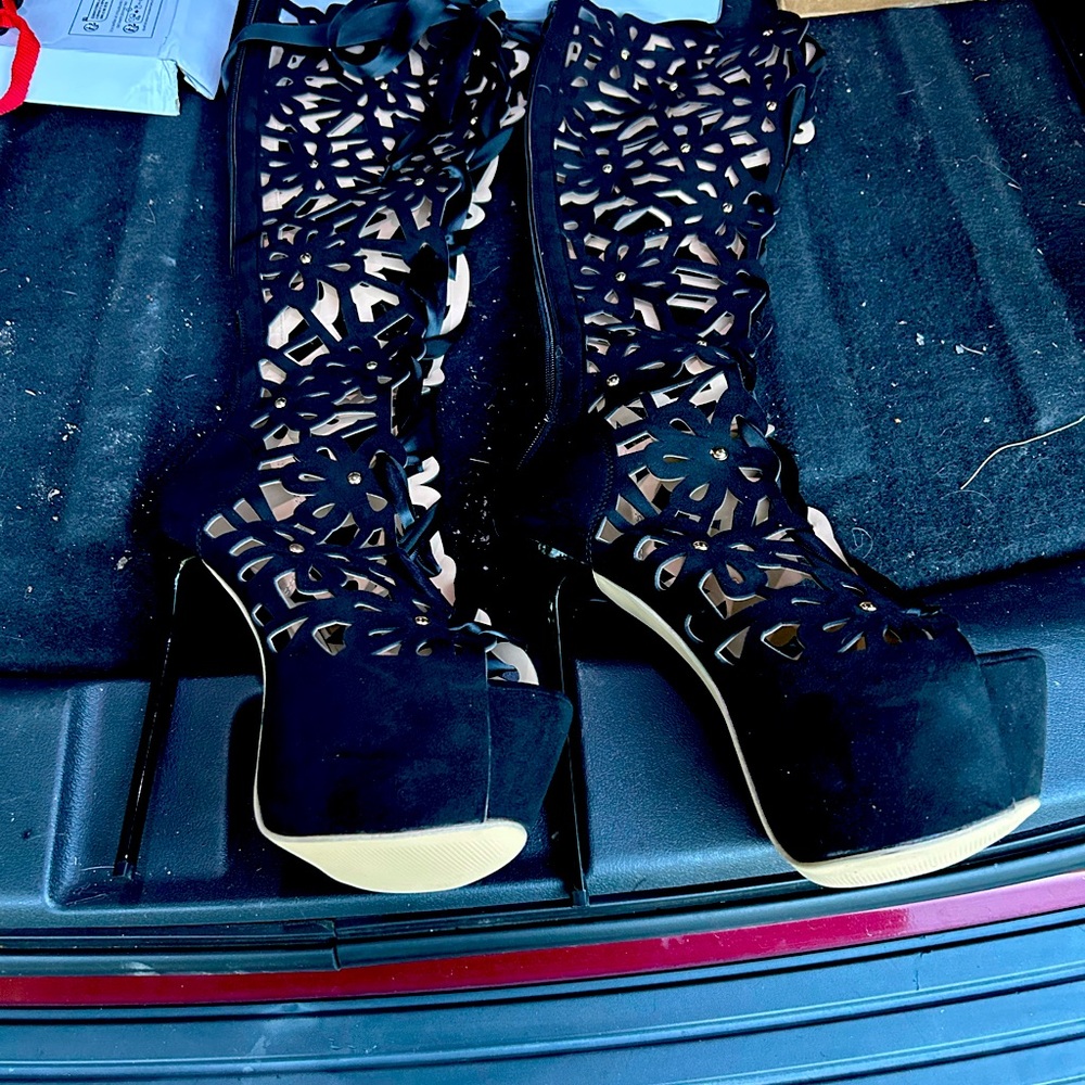 Brand new never worn knee high heels they zip up in back and have a lace bow.